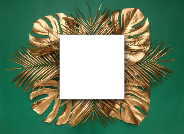 istock Golden tropical leaves on green background 1140015801
