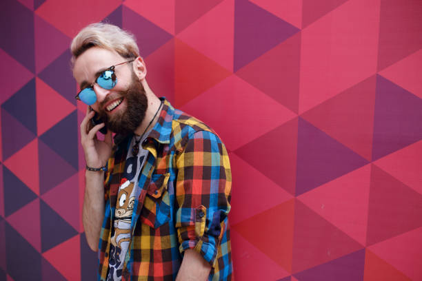 istock Handsome charismatic young man talking on mobile phone, on a multicolored background. 1140016966