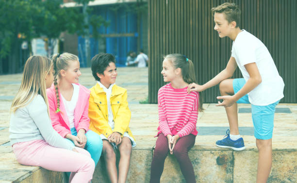 istock Two boys and three girls are talking about play on walk 1140018680