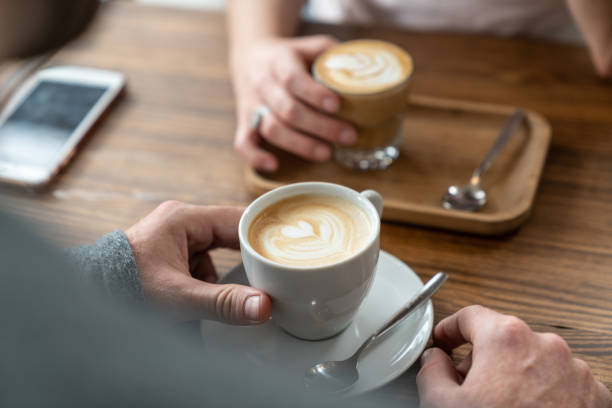 istock Close up of unrecognizable couple enjoying warm drinks at the bakery 1140018894