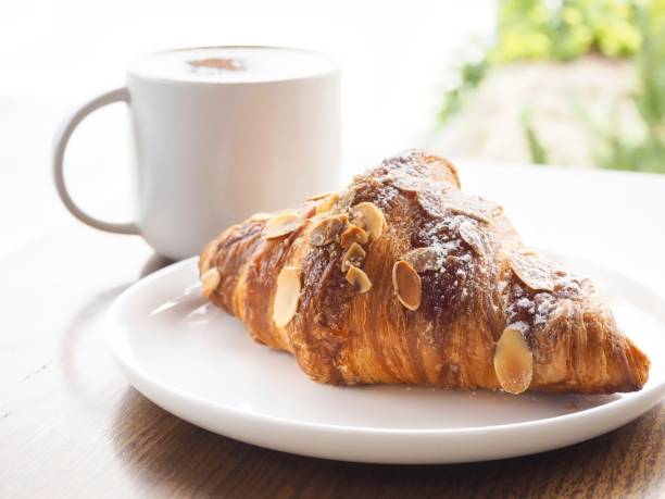 Freshly Baked Almond Croissant With Cafe Latte stock photo