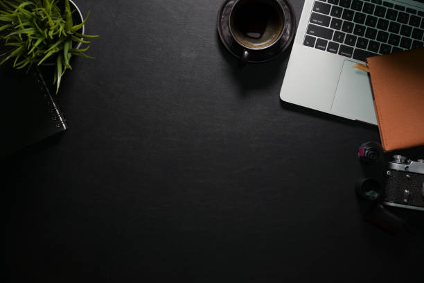 istock Office leather desk with laptop, camera, coffee and copy space 1140022770