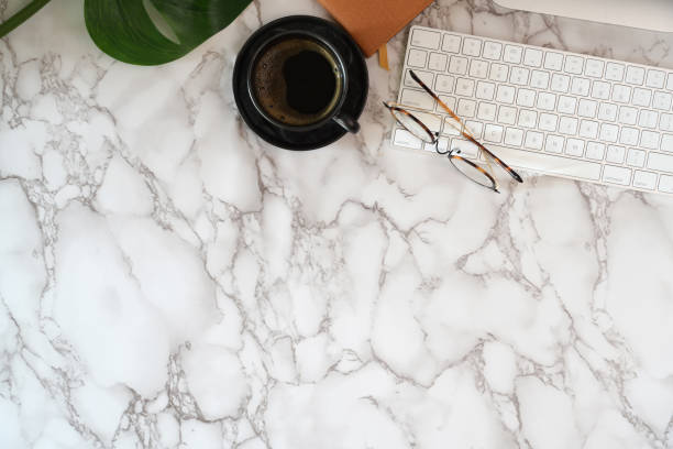 istock Office desk with office supplies on marble desk top table 1140022969