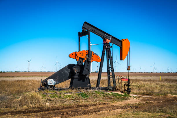 istock Oil pump surrounded by massive wind farm in west Texas 1140032658