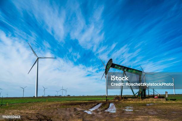 West Texas Oil Industry Using Wind Energy To Power Fossil Fuels Stock Photo - Download Image Now