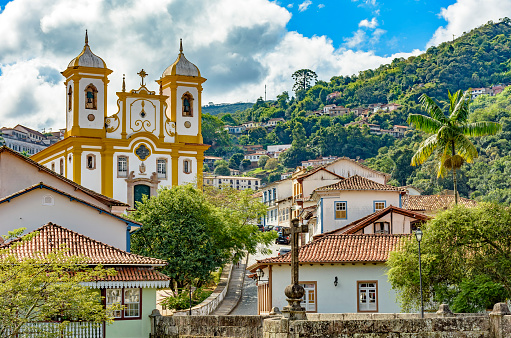 Top view of the center of the historic Ouro Preto city in Minas Gerais, Brazil with its famous churches and old buildings with hills in background