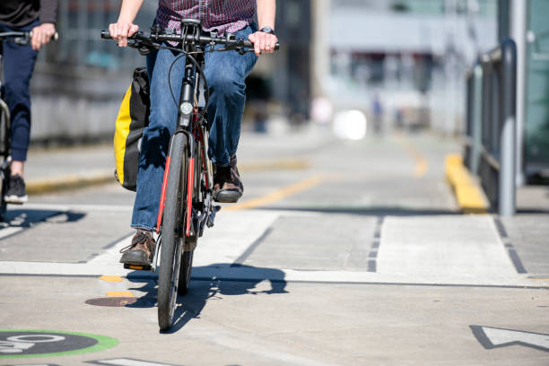 istock Cyclists ride along bicycle lane in sunny day 1140034558