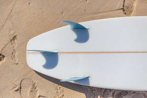 Surfboard fins and beach sand