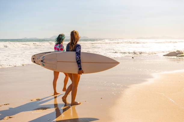 istock Middle Aged Women Going for a Surf at the Beach 1140036415
