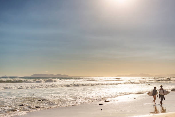istock Surfers Going Home After a Surf at the Beach 1140036430