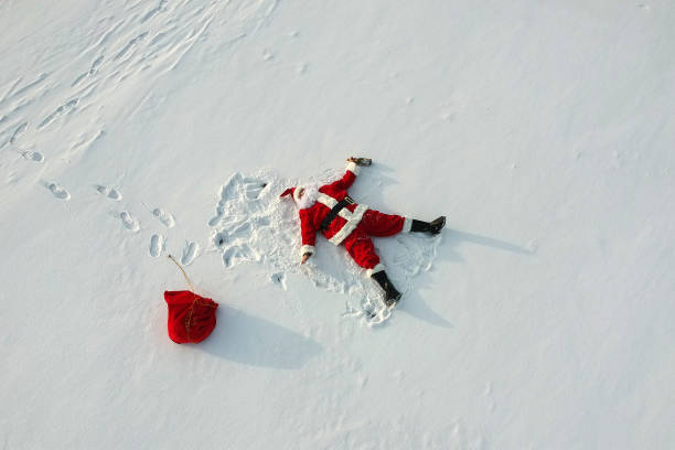 istock Santa claus lying on the snow 1140043874