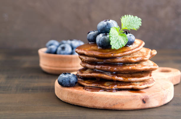istock Chocolate pancakes with blueberries on a dark background. 1140049627