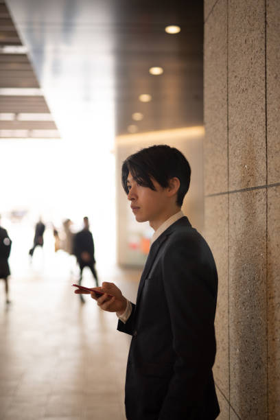 istock Young businessman watching smart phone on street 1140051146