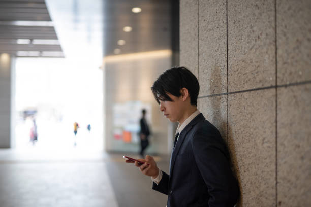 istock Young businessman watching smart phone on street 1140051183