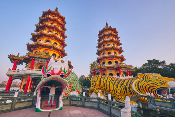 3 décembre 2018: les gens viennent au mérite à cih ji dragon et tigre pagodes sur l’étang de lotus à l’heure du coucher du soleil, la ville de kaohsiung. - great dagon pagoda photos et images de collection