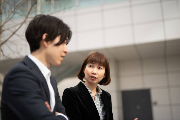 istock Female manager talking to younger businessman 1140051470