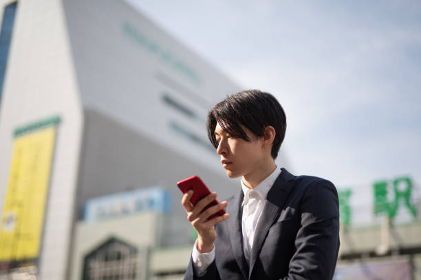 istock Young businessman watching smart phone on street 1140052145