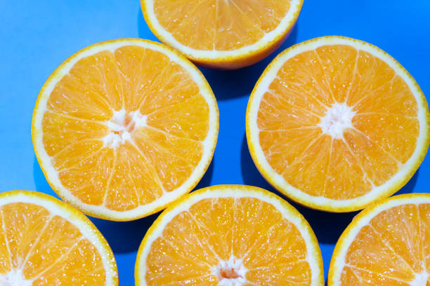 istock Orange halves on colorful background 1140052277