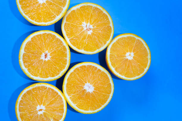 istock Orange halves on colorful background 1140052436