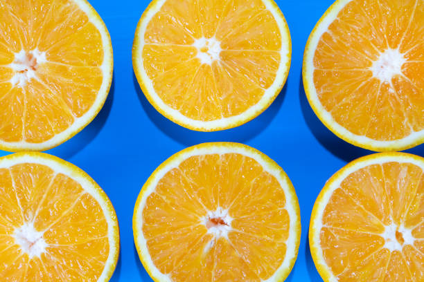 istock Orange halves on colorful background 1140054488