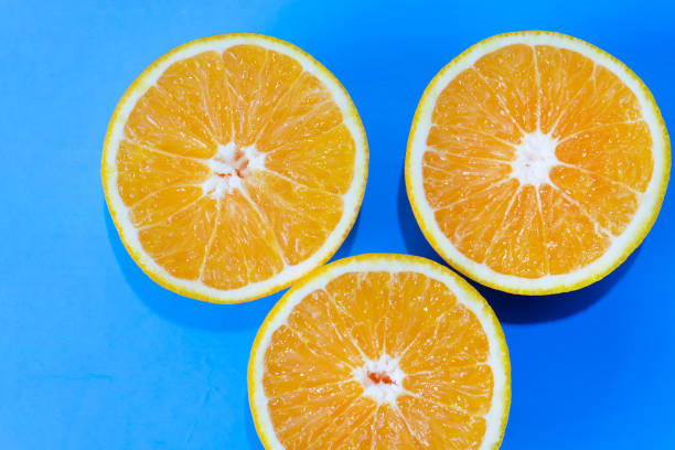 istock Orange halves on colorful background 1140055187