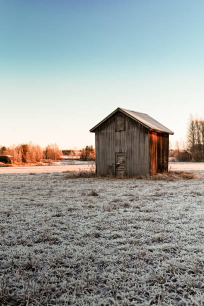 крошечный сарай дом на морозных полях - winter finland agriculture barn стоковые фото и изображения