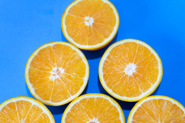 istock Orange halves on colorful background 1140055639