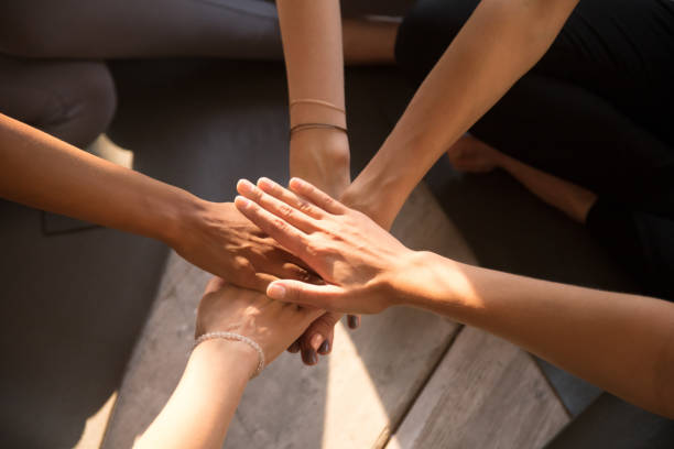 istock Top view of women stack hands engaged in teambuilding activity 1140056236