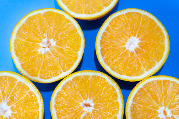 istock Orange halves on colorful background 1140056398
