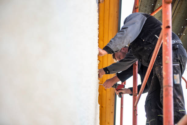 istock Construction workers installing wooden planks on house facade 1140059749
