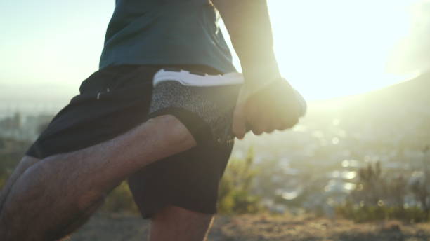 istock Runner warming up for a run. White male stretching in park ready for his run 1140059977