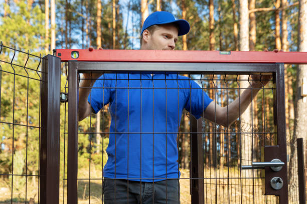 man check the level of new fence gates man check the level of new fence gates yard measurement stock pictures, royalty-free photos & images