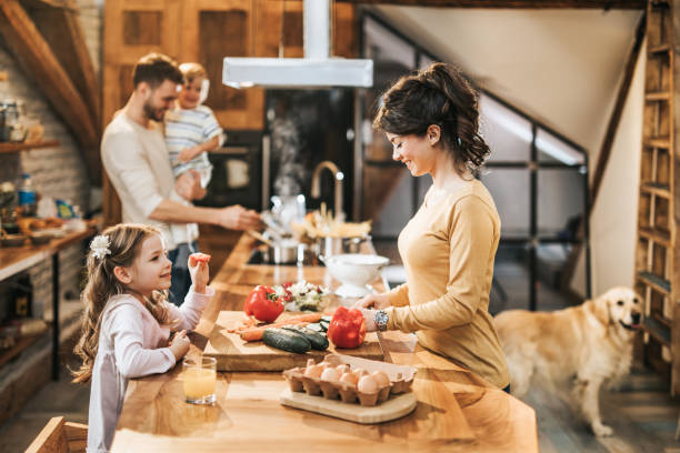 istock Young family preparing lunch in the kitchen. 1140065854