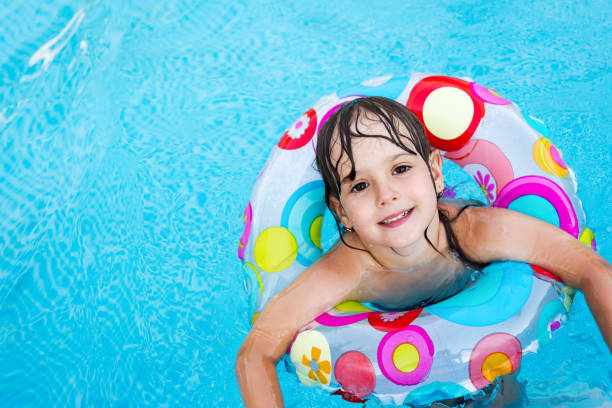 istock Little girl in swimming pool with float ring 1140066062