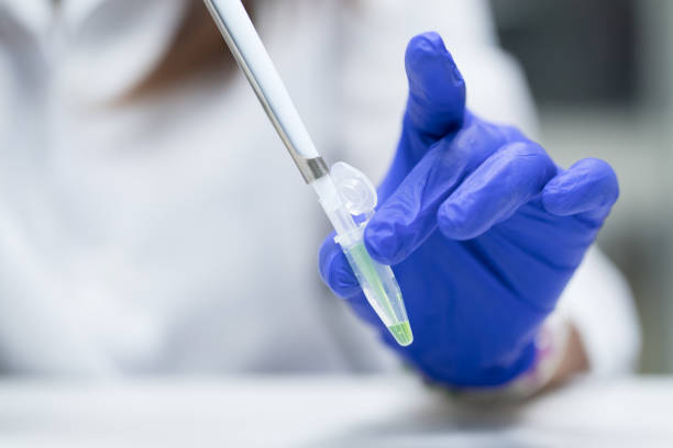 istock Scientist with pipette and test tube, examining samples and liquid in laboratory 1140067540