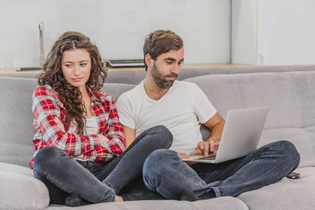 istock A good couple while shopping online using a laptop and smiling while sitting at a couch at home. A woman was offended by a man because he did not make her purchase online. 1140067595