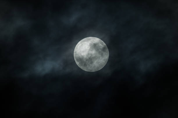 Full Moon and clouds on the night sky stock photo