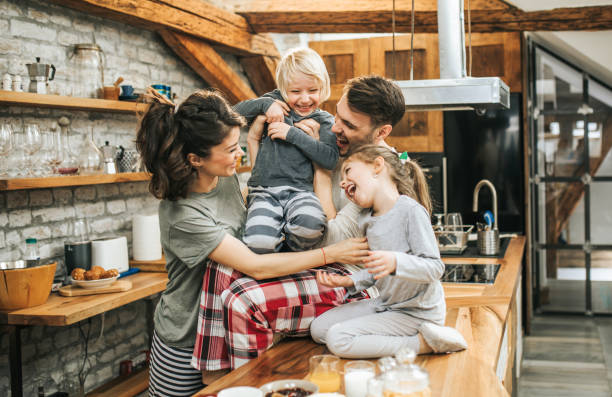 istock Young cheerful family having fun in the kitchen. 1140067833