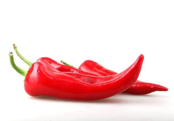 Close-Up Of Red Chili Pepper Against White Background