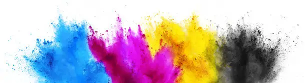 Photo of colorful CMYK cyan magenta yellow key holi paint color powder explosion print concept isolated white background