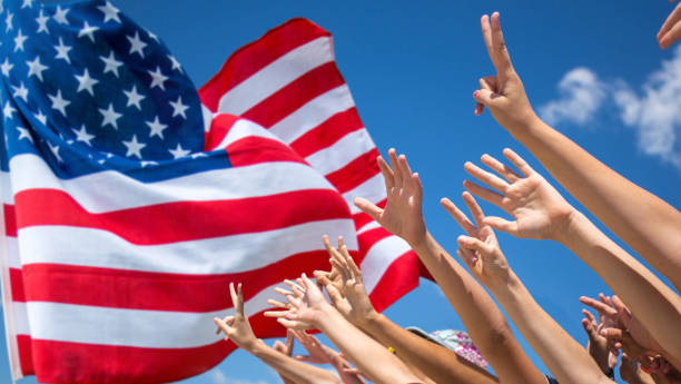 istock Group of People Waving American Flags 1140073860