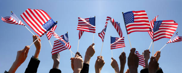 istock Group of People Waving American Flags 1140073861
