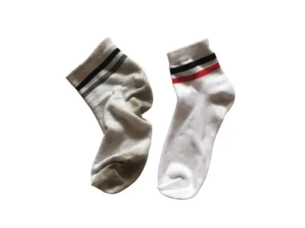 Photo of Used and new soft socks isolated on white background