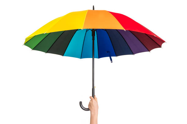 istock Rainbow umbrella in female hand isolated on white 1140079369