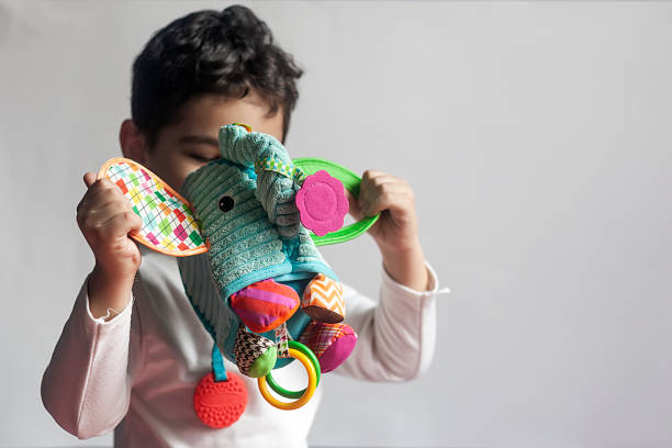 istock 5 years adorable little kid boy playing with plush elephant toy 1140080227