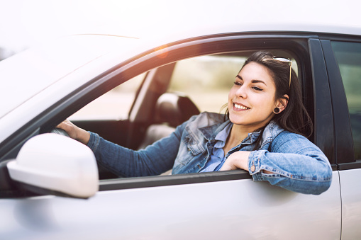 Beautiful women on the road, enjoying the ride with beautiful smile out of window, Young traveler enjoying the ride o the road, Travel Vacantion