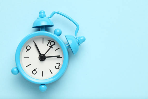istock Blue alarm clock isolated on blue background 1140085377