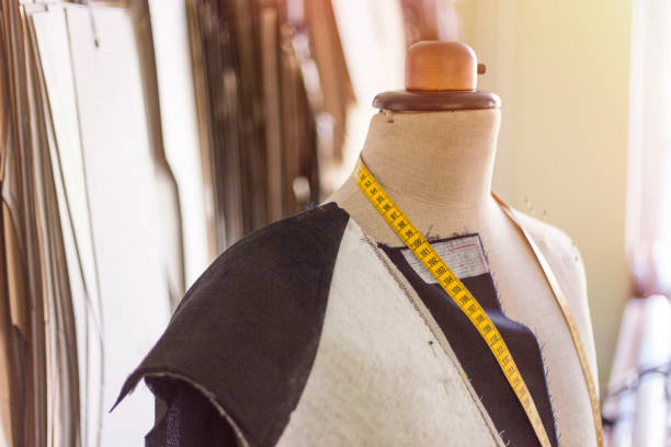 istock Tailored suit jacket on a mannequin during construction at bespoke tailor's workshop. 1140085974