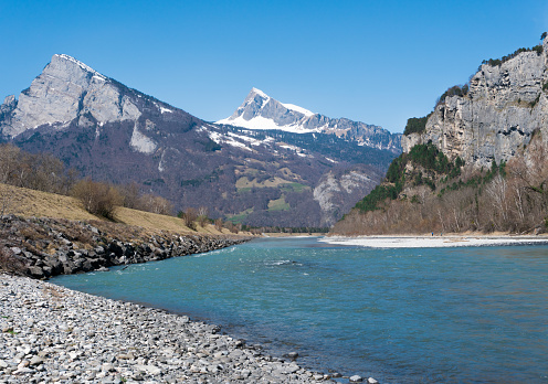 Rhine river in the springtime with snow-capped mountain peak landscape of Switzerland in the bakcground