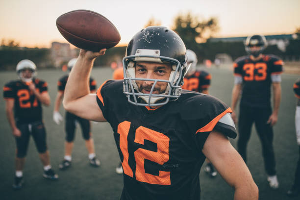 istock Football player holding a ball on training 1140092026